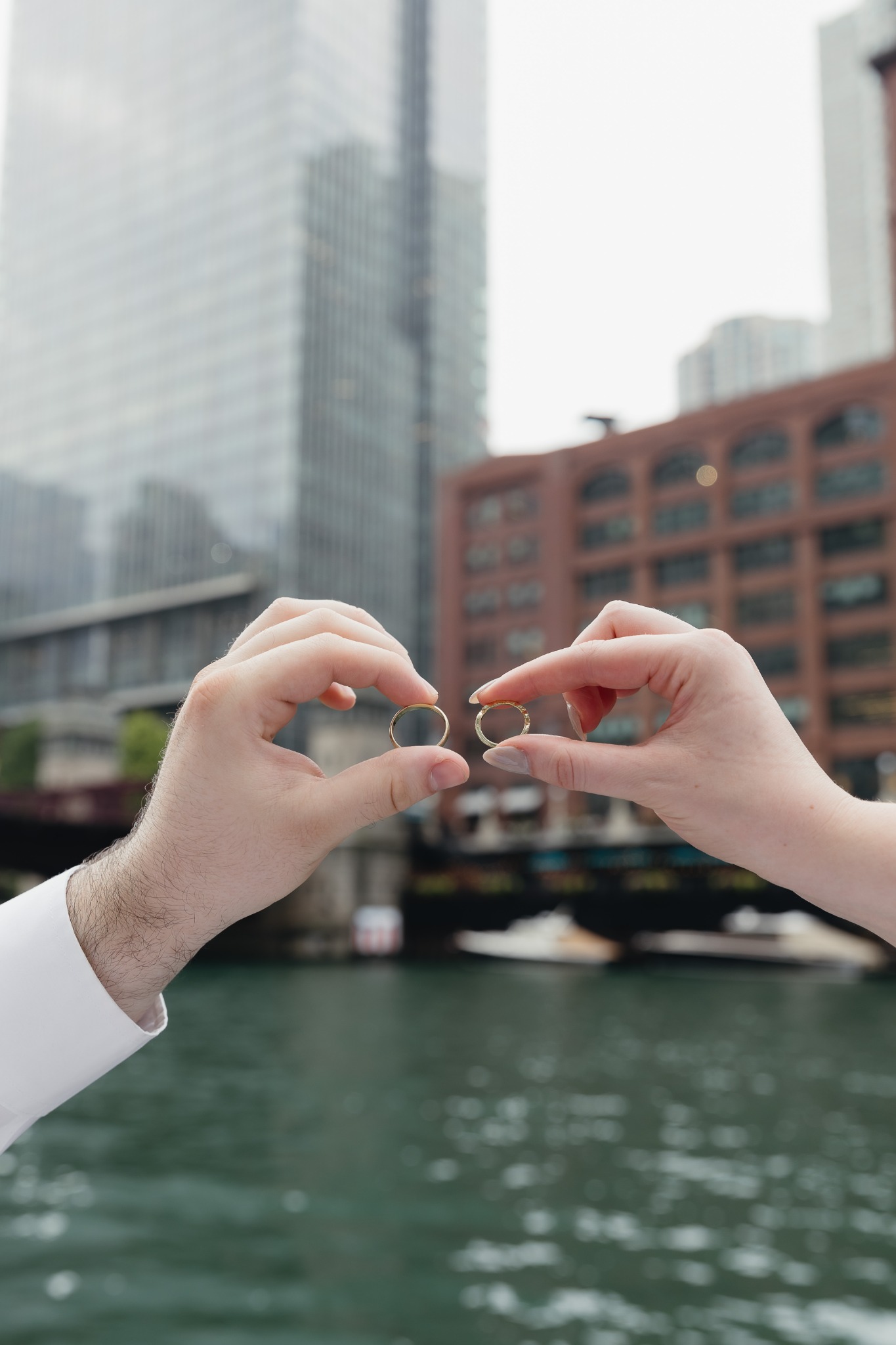 Sydney and Jack holding their wedding rings